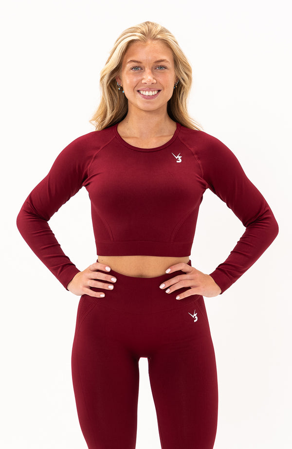 V3 Apparel Women's Tempo seamless long sleeve cropped training top in burgundy red with thumb hole long sleeves and crop fit for gym workouts training, Running, yoga, bodybuilding and bikini fitness.